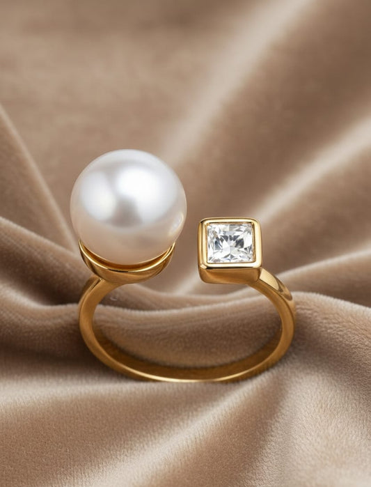 Gold ring with a pearl and diamond on a beige fabric background