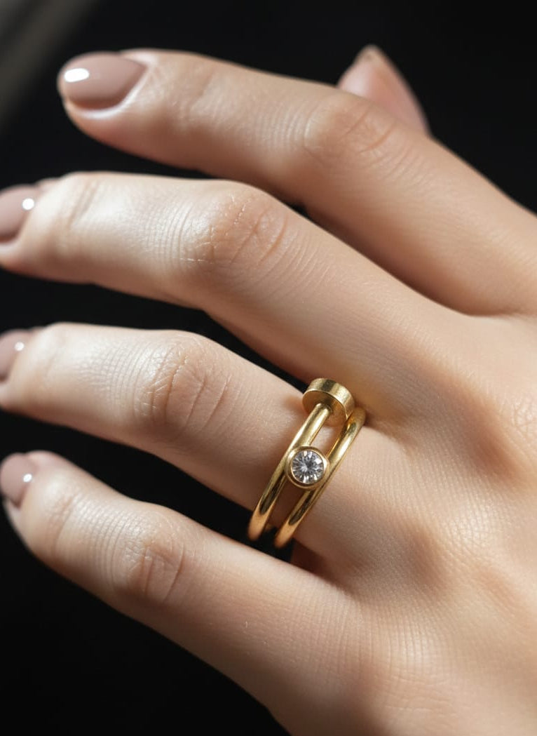 Gold ring with a diamond on a hand against a dark background