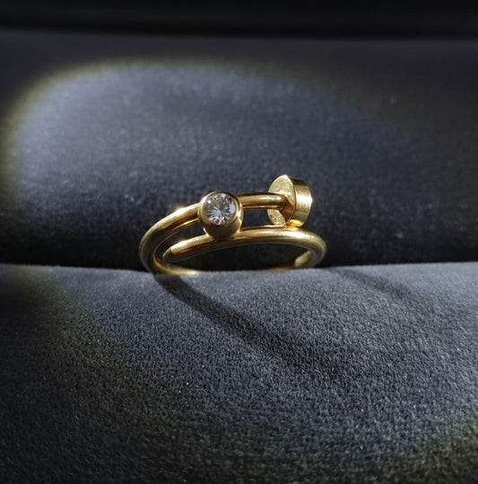 Gold ring with gemstones on a dark fabric background