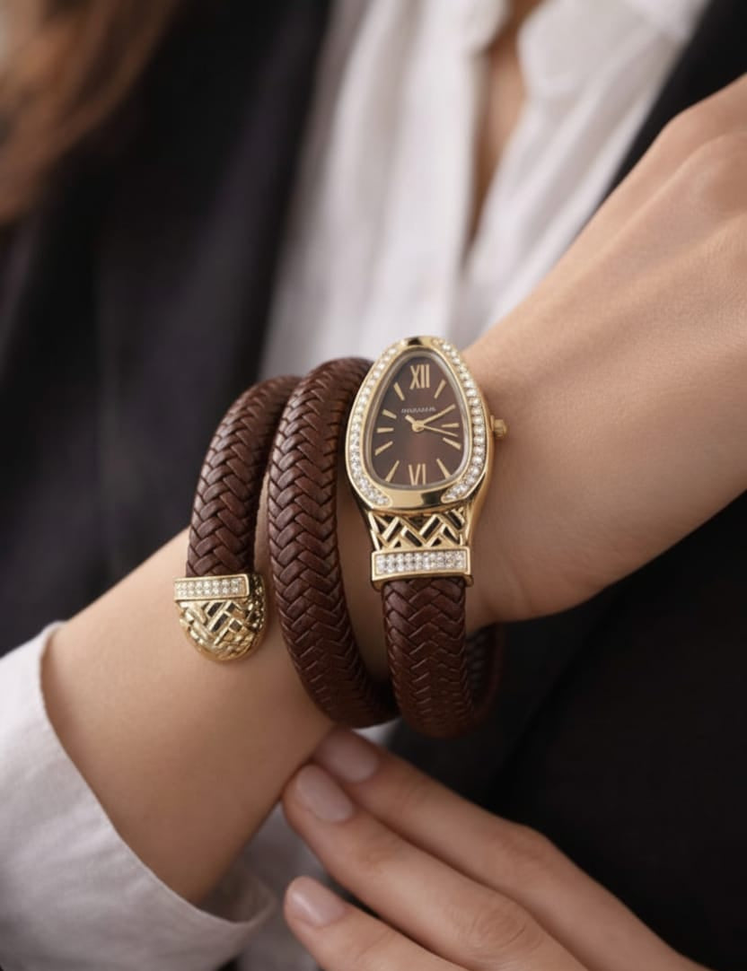 Gold watch and brown leather bracelet on a wrist with a blurred background
