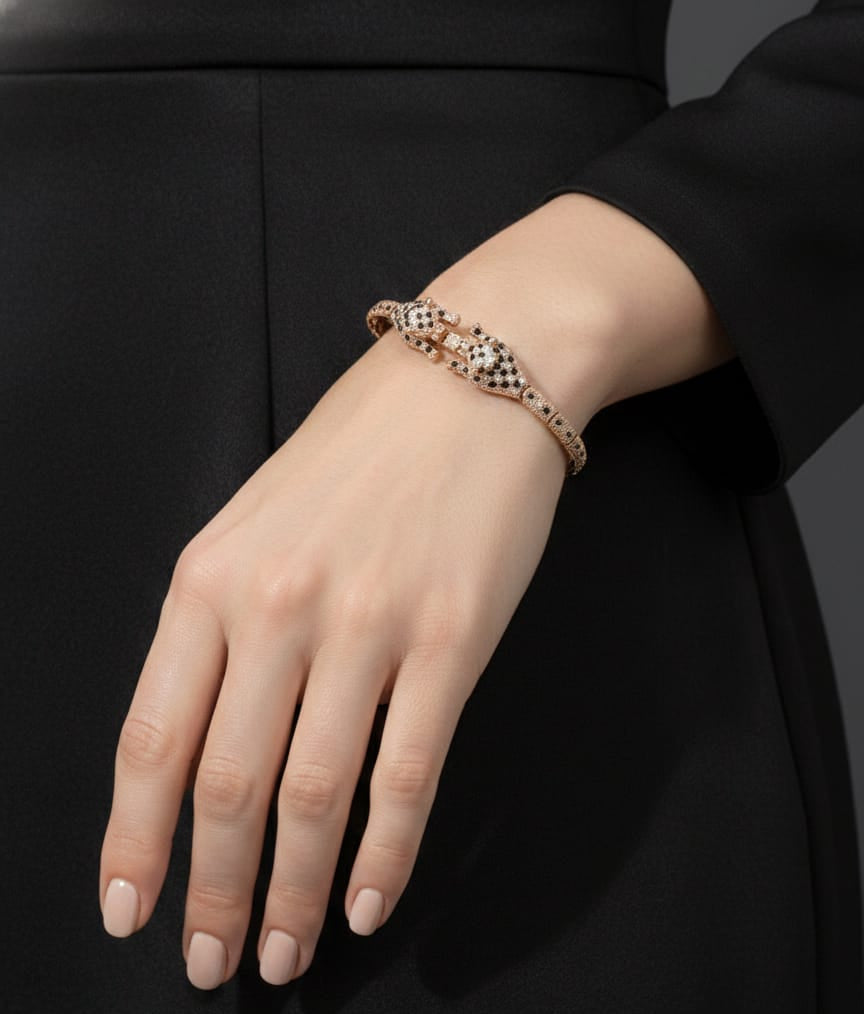 Hand wearing a bracelet on a black background