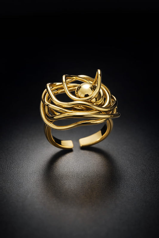 Gold ring with a unique design on a black background