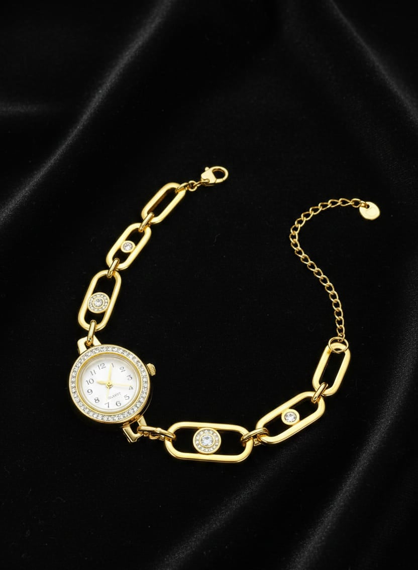 Gold chain bracelet with a watch face on a black background
