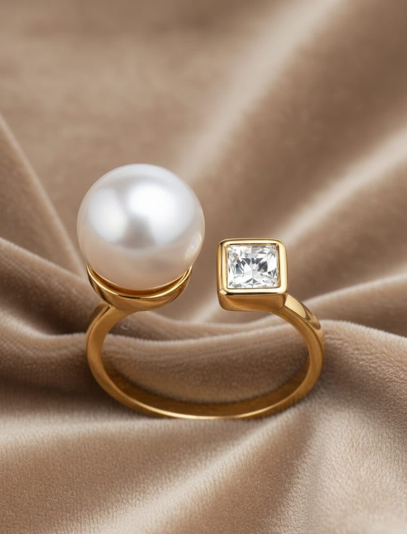 Gold ring with a pearl and diamond on a beige fabric background