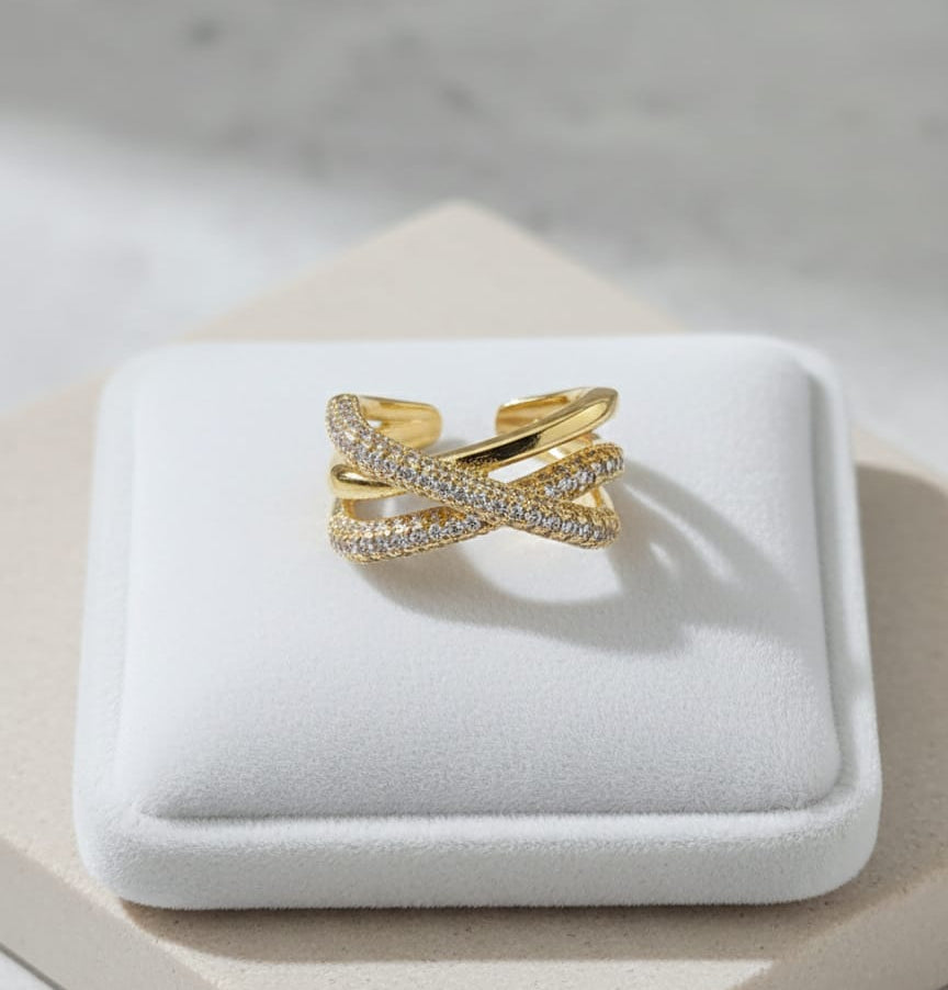 Gold ring with diamonds on a white jewelry box