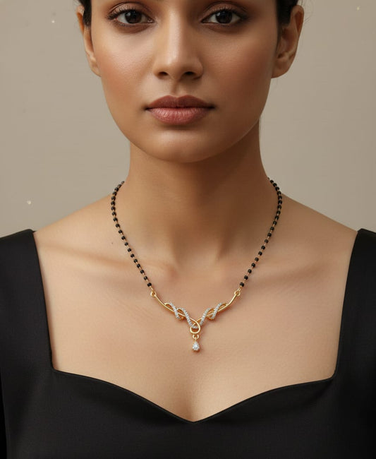 Woman wearing a gold necklace with a pearl pendant on a neutral background