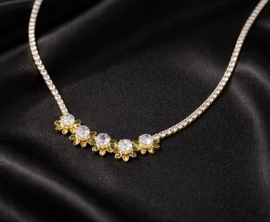 Gold necklace with diamond-like stones on a black satin background