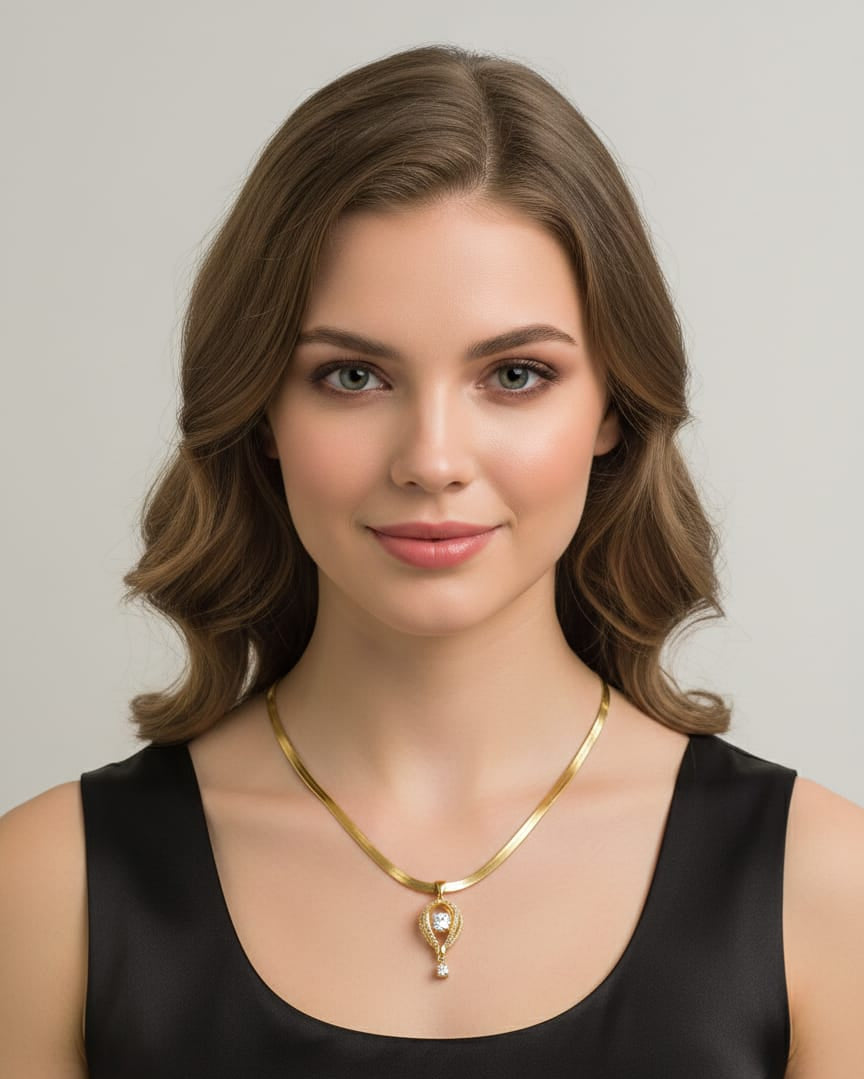 Woman wearing a gold necklace against a neutral background