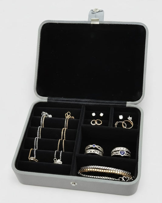 Jewelry organizer with rings, necklaces, and earrings on a white background